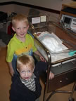 First grand-daughter Elizabeth Kathryn Bondy in her bassinette with her brothers Cameron and Ryan.