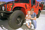 Daughter Lisa, grandson Logan, big red Hummer