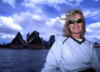 Pam in Sydney harbor with opera house in background.